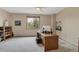 Neutral-toned bedroom featuring a desk area, a window with views, carpeted floors, and guitars at 8403 Homestake Ct, Larkspur, CO 80118