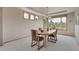 Bright dining room featuring a wooden table and chairs beneath a chandelier with views of the backyard at 8403 Homestake Ct, Larkspur, CO 80118