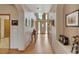 Spacious entrance hall with hardwood floors and an arched doorway at 8403 Homestake Ct, Larkspur, CO 80118