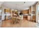 Open kitchen with wood cabinets, a central island with granite countertops, and hardwood floors throughout at 8403 Homestake Ct, Larkspur, CO 80118