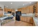 Bright kitchen with wooden cabinets, granite countertops, and modern appliances for a pleasant cooking experience at 8403 Homestake Ct, Larkspur, CO 80118