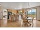 Inviting kitchen with light-colored cabinets, granite countertops, and a breakfast bar with adjacent dining area at 8403 Homestake Ct, Larkspur, CO 80118