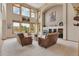 Bright living room with a fireplace, vaulted ceilings, and large windows showcasing a beautiful outdoor view at 8403 Homestake Ct, Larkspur, CO 80118