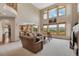 Spacious living room with large windows overlooking a scenic mountain view and an open layout at 8403 Homestake Ct, Larkspur, CO 80118
