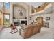 Cozy living room featuring a fireplace, neutral décor, and a glimpse of the upper-level balcony at 8403 Homestake Ct, Larkspur, CO 80118