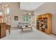 Bright living room with large windows and a bookcase with beautiful interior decoration at 8403 Homestake Ct, Larkspur, CO 80118