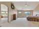 Bright main bedroom with neutral colors, views, ceiling fan, and access to the attached bathroom at 8403 Homestake Ct, Larkspur, CO 80118