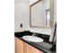 Bathroom features a black granite countertop, a white sink, and an ornate mirror at 10152 Bluffmont Ln, Lone Tree, CO 80124