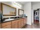 Spacious bathroom with double sinks, framed mirrors, and tile flooring at 10152 Bluffmont Ln, Lone Tree, CO 80124