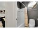 Bathroom with shower-tub combo and a toilet with stylish gray paint at 10152 Bluffmont Ln, Lone Tree, CO 80124