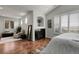 Relaxing bedroom with fireplace, shuttered windows, and sitting area at 10152 Bluffmont Ln, Lone Tree, CO 80124