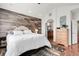 A cozy bedroom featuring stylish decor and a view into an ensuite bathroom at 10152 Bluffmont Ln, Lone Tree, CO 80124