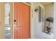 Inviting front entrance with a vibrant door, stylish lighting, and manicured greenery at 10152 Bluffmont Ln, Lone Tree, CO 80124