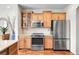 Bright kitchen showcasing wooden cabinets, granite countertops, and stainless steel appliances at 10152 Bluffmont Ln, Lone Tree, CO 80124