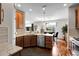 Well-lit kitchen with granite countertops, wooden cabinets, stainless steel appliances, and an adjacent dining area at 10152 Bluffmont Ln, Lone Tree, CO 80124