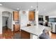 Bright kitchen featuring wooden cabinets, a granite countertop island and a breakfast bar with seating at 10152 Bluffmont Ln, Lone Tree, CO 80124
