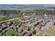 Expansive aerial view of a residential area with homes, roads and grassy areas with surrounding mountain scenery at 4090 Forever Cir, Castle Rock, CO 80109