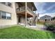 Backyard view featuring lawn, stone landscaping, and second story deck with stairs at 4090 Forever Cir, Castle Rock, CO 80109