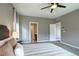 Bright bedroom with ceiling fan, neutral walls, and doorways to other rooms at 4090 Forever Cir, Castle Rock, CO 80109