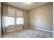 This bedroom is brightly lit and features neutral walls, plush carpeting, and sun-blocking shades at 4090 Forever Cir, Castle Rock, CO 80109