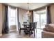 Cozy dining area with a modern chandelier, large windows, and access to the outdoor deck at 4090 Forever Cir, Castle Rock, CO 80109