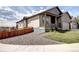 Exterior side view of home featuring neutral siding, stone accents, and a fenced yard at 4090 Forever Cir, Castle Rock, CO 80109