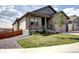 Inviting home exterior with a covered porch, tasteful landscaping and an attached two car garage at 4090 Forever Cir, Castle Rock, CO 80109