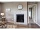 Close-up of the fireplace with tile surround, modern mirror, and 'choose kindness' sign at 4090 Forever Cir, Castle Rock, CO 80109
