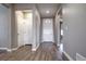 Elegant foyer with hardwood floors, white trim, and neutral gray walls, leading to other rooms at 4090 Forever Cir, Castle Rock, CO 80109