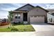 Charming front exterior featuring a lawn, a two car garage and stone accents at 4090 Forever Cir, Castle Rock, CO 80109