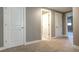 Neutral hallway featuring carpeted floors, gray walls, and white doors leading to various rooms at 4090 Forever Cir, Castle Rock, CO 80109