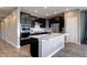Stylish kitchen featuring black cabinets, stainless steel appliances, and a large center island at 4090 Forever Cir, Castle Rock, CO 80109