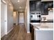 Modern kitchen with stainless steel appliances and ample cabinet space; access to other rooms beyond at 4090 Forever Cir, Castle Rock, CO 80109
