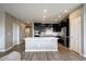 Modern kitchen with sleek black cabinetry, stainless steel appliances, and a spacious center island at 4090 Forever Cir, Castle Rock, CO 80109