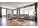 Bright and airy living room with large windows, comfortable sofas, and a stylish chandelier at 4090 Forever Cir, Castle Rock, CO 80109