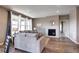 Bright living room with a cozy fireplace and natural light streaming through the large windows at 4090 Forever Cir, Castle Rock, CO 80109