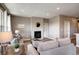 Spacious living room with a decorative fireplace, comfortable couches, and ample natural light at 4090 Forever Cir, Castle Rock, CO 80109
