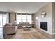 Cozy living room with a fireplace, plush sofas, and large windows, creating a comfortable atmosphere at 4090 Forever Cir, Castle Rock, CO 80109