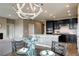 Open-concept design with dining area, stylish chandelier, and seamless flow into the kitchen at 4090 Forever Cir, Castle Rock, CO 80109