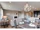 Open-concept living area showcasing a dining table, fireplace, and seamless flow to the kitchen at 4090 Forever Cir, Castle Rock, CO 80109