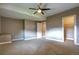 Neutral main bedroom with carpet flooring, ceiling fan, and an ensuite bathroom with a walk-in closet at 4090 Forever Cir, Castle Rock, CO 80109