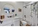 Bathroom featuring a modern vanity with a round mirror and a shower-tub with a decorative shower curtain at 12193 W 51St Ave, Wheat Ridge, CO 80033