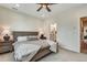 Spacious bedroom with neutral tones, plush carpet, and view into bathroom, offering a serene retreat at 12193 W 51St Ave, Wheat Ridge, CO 80033
