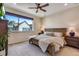 Bedroom featuring ceiling fan, large window, neutral colored walls, and matching wood furniture at 12193 W 51St Ave, Wheat Ridge, CO 80033