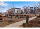 A view of several modern townhomes from a community green space and playground at 12193 W 51St Ave, Wheat Ridge, CO 80033