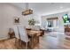 Bright dining area with rustic table and seating flows into a cozy living room with natural light at 12193 W 51St Ave, Wheat Ridge, CO 80033