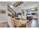 Dining area showcases rustic table and upholstered chairs, with a view to the kitchen and staircase at 12193 W 51St Ave, Wheat Ridge, CO 80033