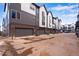 A row of modern townhomes, featuring individual garages and well-maintained landscaping at 12193 W 51St Ave, Wheat Ridge, CO 80033