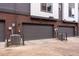 Exterior view of a garage with gray doors and individual air conditioning units for each unit at 12193 W 51St Ave, Wheat Ridge, CO 80033