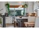 Bright kitchen with a large window, pendant lights, and a view to the dining area at 12193 W 51St Ave, Wheat Ridge, CO 80033